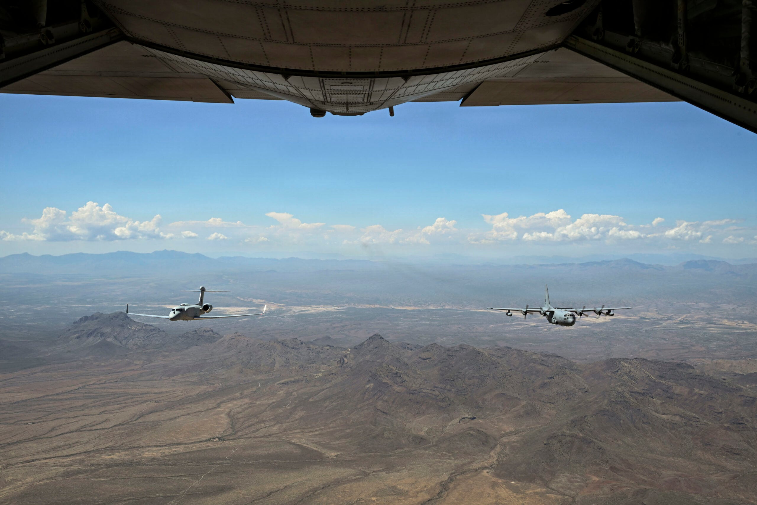 A U.S. Air Force EC-130H Compass Call aircraft and an EA-37B Compass Call aircraft assigned to the 55th Electronic Combat Group fly in formation over Southern Arizona, Sept. 3, 2026. The formation represents the transition from the EC-130H to the EA-37B, ensuring the Air Force retains its premier airborne electromagnetic attack capability while advancing the mission for future conflicts. (U.S. Air Force photo by Airman 1st Class Samantha Melecio)